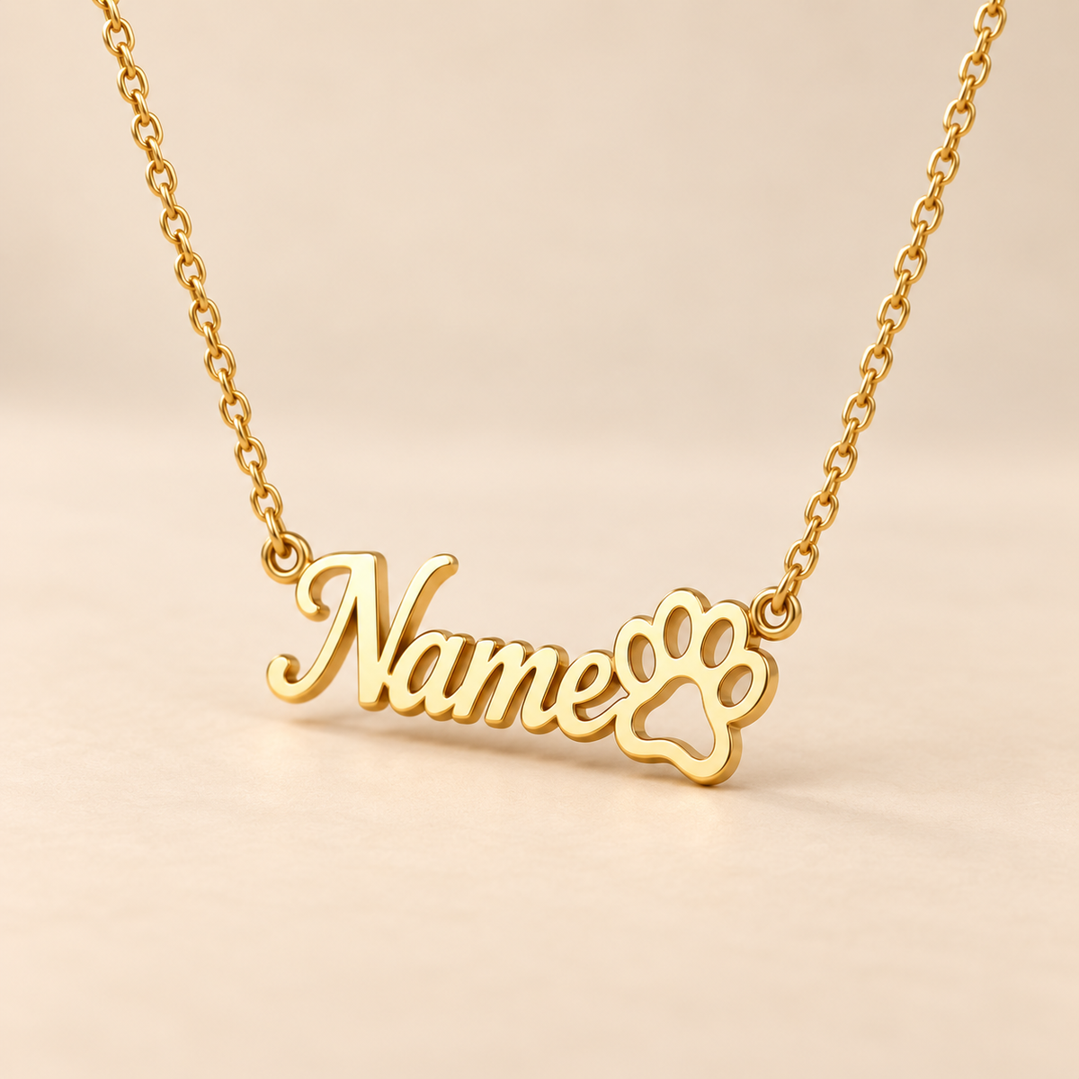 Custom paw print name necklace on warm beige background, angled view