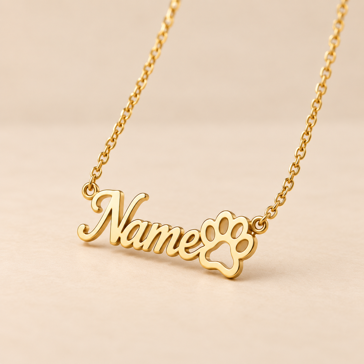 Custom paw print name necklace close-up on warm beige background